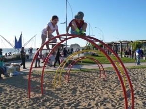 Aliya & Asher playing on structures at the beach