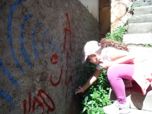 Aliya spray painting her tag