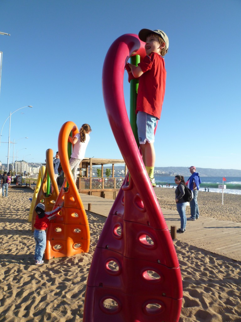 Asher playing on colorful toy at beach